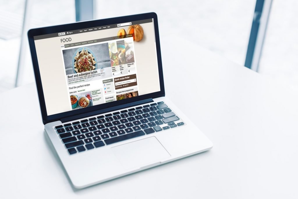 laptop with bbc food website on white tabletop